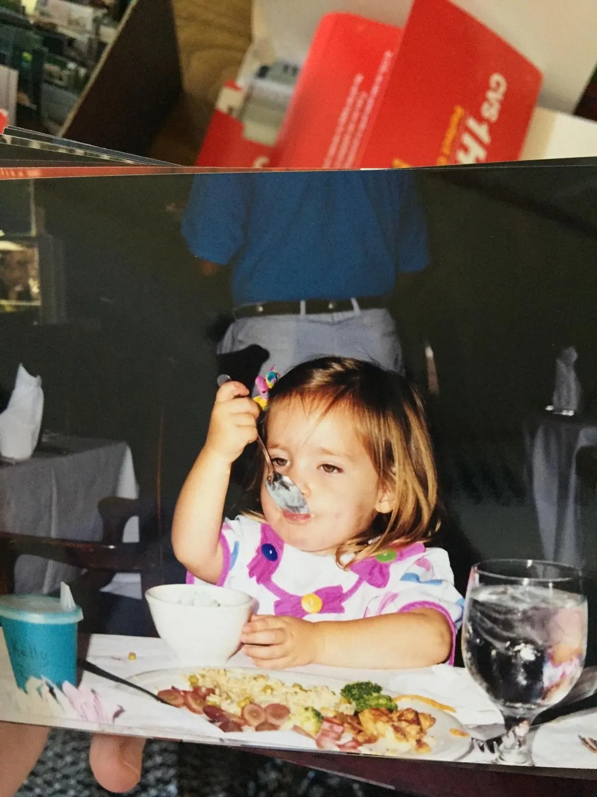 Kelly as a child, happily eating an ice cream cone.